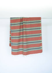 Striped Turkish towel with red and blue pattern on a white background