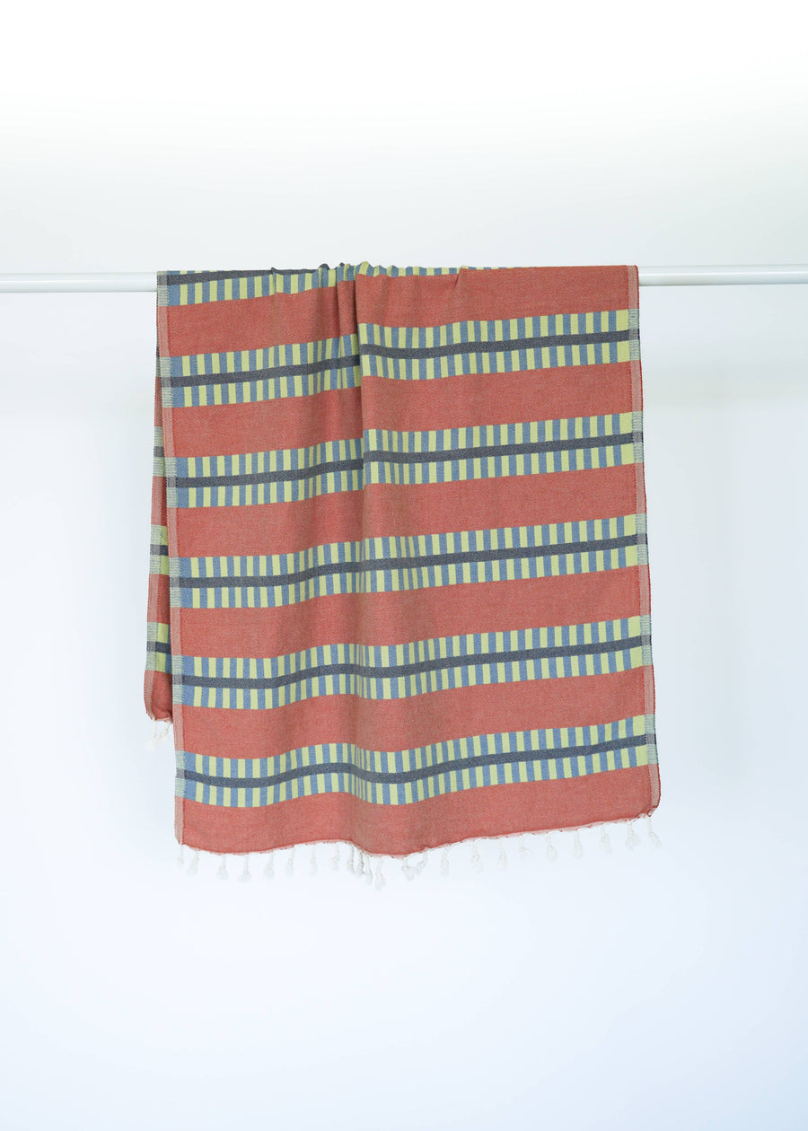 Striped Turkish towel with red and blue pattern on a white background